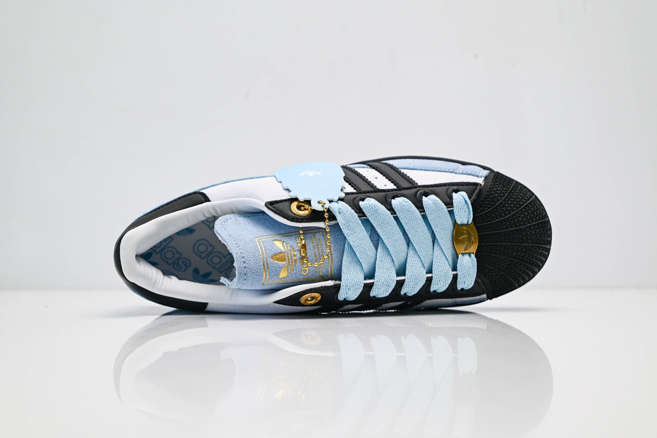 adidas Originals Superstar – Light Blue Upper with White 3-Stripes, Black Heel Tab & Gold Accents